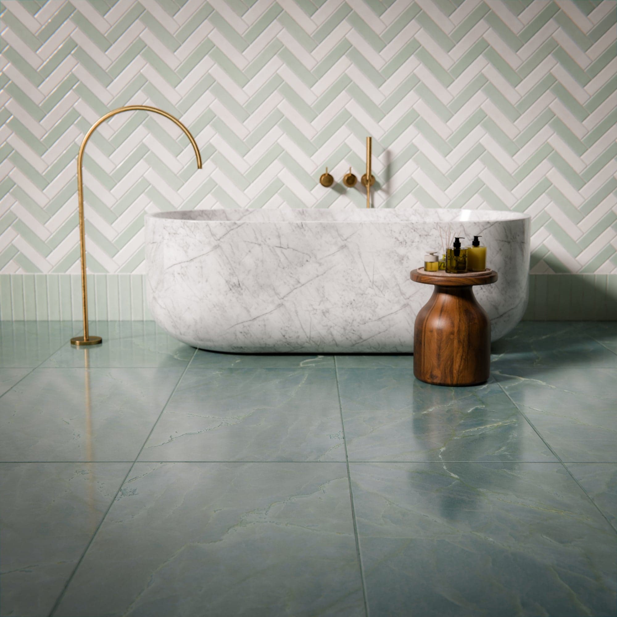 Sage green herringbone wall tiles and a marble bathtub
